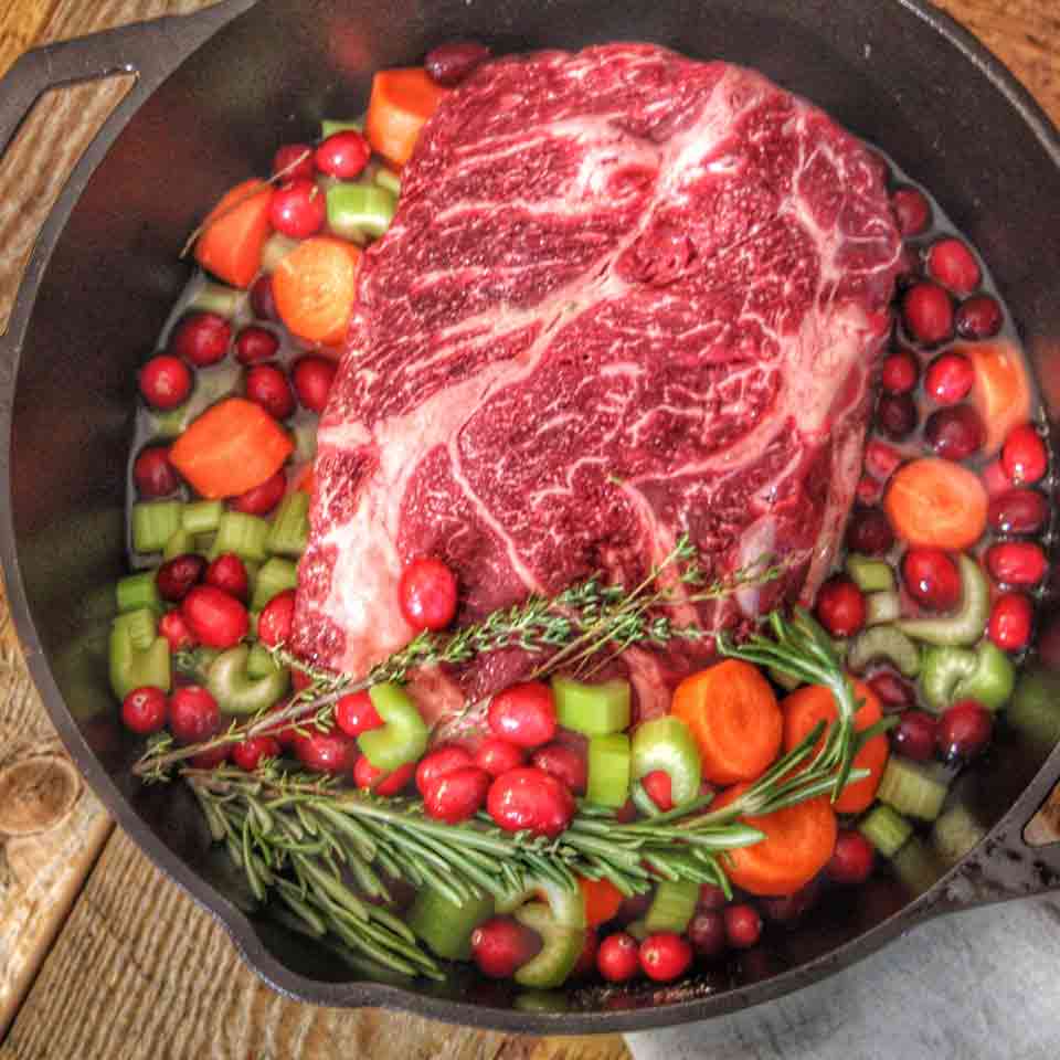 Cranberry Pot Roast, uncooked, in a dutch oven.